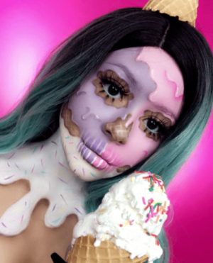 A woman with green hair holding an ice cream cone in front of her head