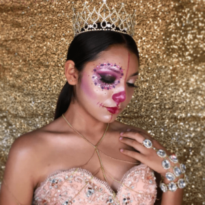 Beauty makeup: a woman in a pink dress with a crown on her head for a Quinceanera