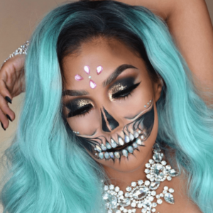 Half glitter skull makeup with a woman with blue hair and skeleton makeup