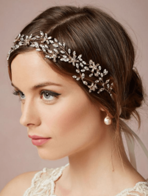 Quinceanera image featuring a woman in a white dress wearing a subtle tiara headband.