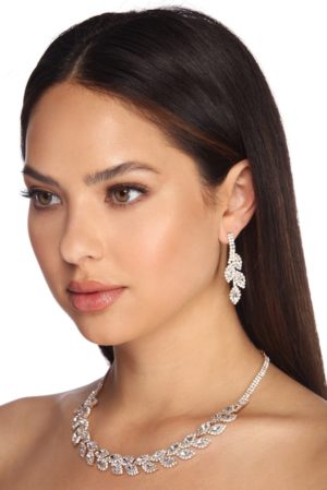 A woman wearing a necklace and earrings