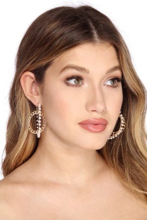 Quinceanera image: A woman with long hair wearing large hoop earrings