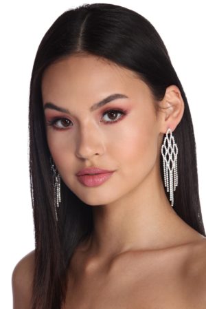 A beautiful woman with long black hair and earrings, showcasing her hair coloring for a Quinceanera