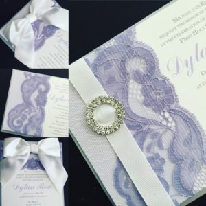 A close up of a lilac Quinceanera invitation with a ring