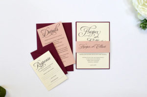 A couple of Quinceanera invitations sitting on top of a table, showcasing a combination of colors for Quinceanera invitations