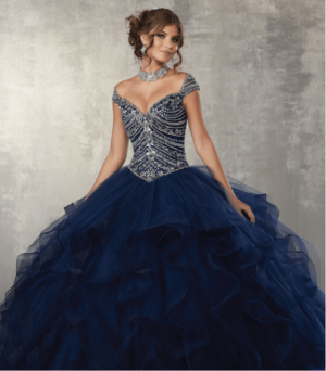 A woman posing for a picture in a navy blue quinceanera dress