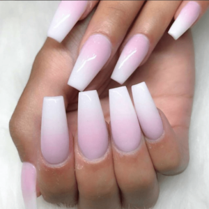 A person holding a pink and white manicure with reverse ombre nails