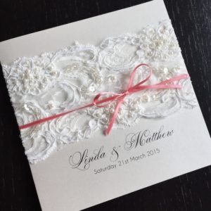 Quinceanera invitation, a white Quinceanera invitation with a pink ribbon