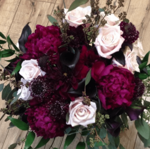Quinceanera: A beautiful floral design, a bouquet of flowers on a wooden floor