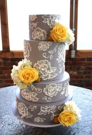 A Quinceanera themed image featuring a grey and yellow color scheme. The image includes a Wedding Invitation and a three-tiered cake with yellow flowers on top.