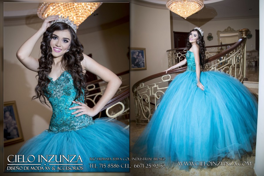 A woman in a blue Quinceañera dress posing for a picture
