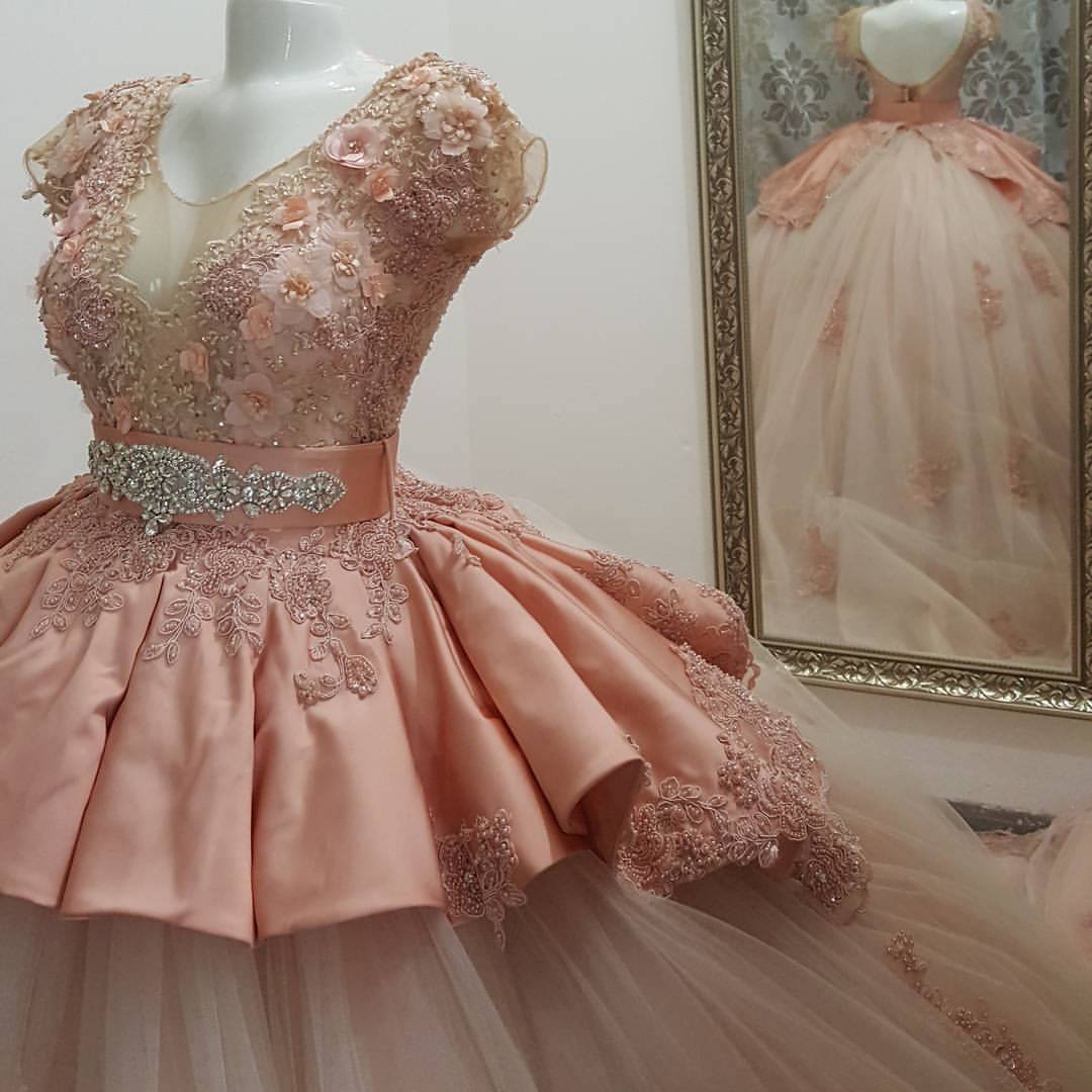 A stunning Quinceañera gown displayed on a mannequin in front of a mirror