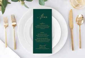 A green menu card with the text 'Quinceanera Invitation' displayed on a white plate