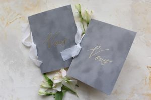 Petal floral design with a couple of books topped with flowers, perfect for a Quinceanera celebration
