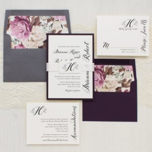 A set of three Quinceanera invitations on a table