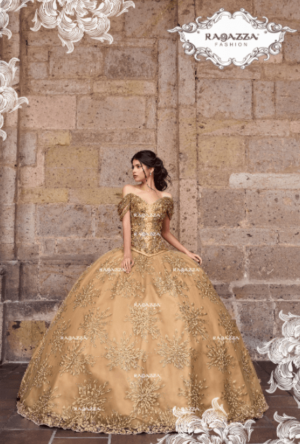 A woman in a gold gown standing in front of a Quinceañera-themed wall
