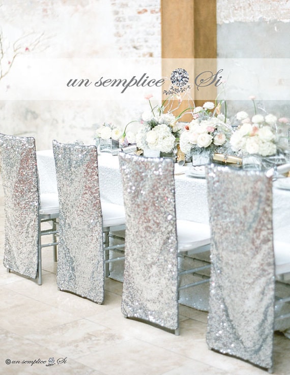 Quinceanera table with silver sequins, flowers, and a flowerpot