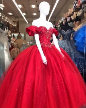 A mannequin in a red Quinceañera gown in a store