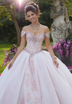 A woman in a Quinceanera ball gown posing for a picture, wearing Morilee Style #89263.