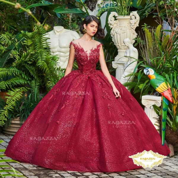 A woman in a red ball gown posing for a picture at a Quinceanera