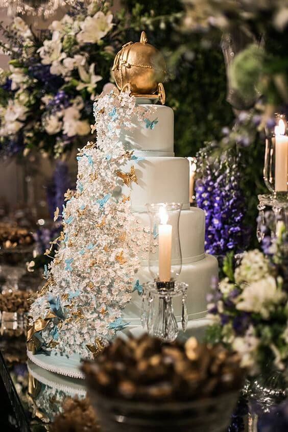 A white wedding cake sitting on top of a table, decorated in a Quinceañera Cinderella theme