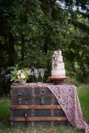 A Quinceanera celebration featuring a beautiful cake sitting on a trunk