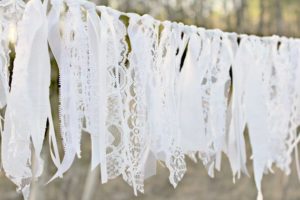 A quinceanera celebration with a string of white lace hanging from a tree