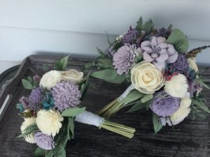 A beautiful floral bouquet with various flowers arranged on a wooden table