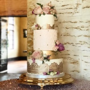 Quinceanera cake, a three tiered cake with flowers on top