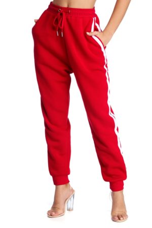 A woman in a crop top and red pants, showcasing LOVER BRAND FASHION for Quinceanera