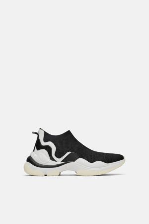 A pair of black and white sneakers, walking shoe