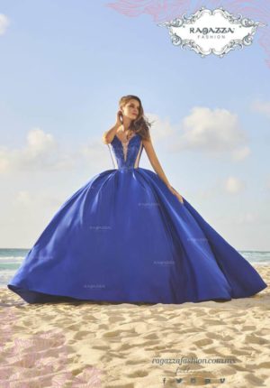 A woman in a blue Quinceanera gown on the beach