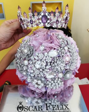 Quinceanera image with a person holding a bouquet topped with a 15th-year crown