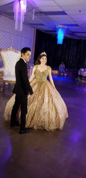 A couple dressed in formal attire in a Quinceanera gown from the 1980s