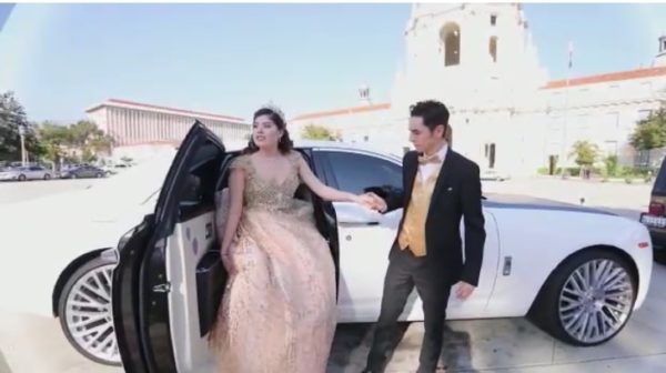 A Quinceanera family standing next to a car