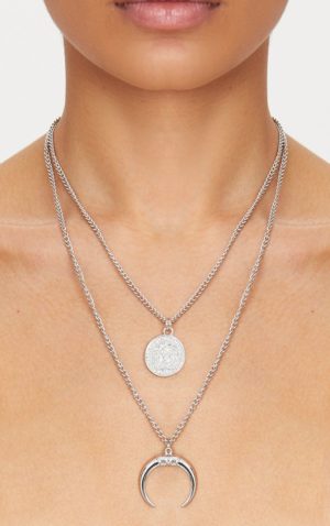A woman wearing a necklace with a crescent charm in a Quinceanera celebration