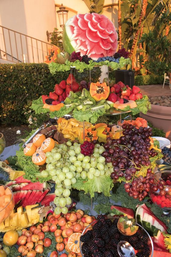 Quinceanera fruit tower, a table topped with lots of different types of fruit