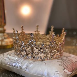 A Quinceanera crown with jewellery, Karbala, placed on top of a pillow on a table