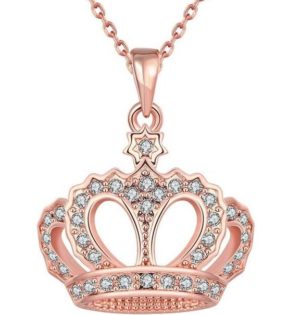 A petal necklace, a white rose, and a pink rosary on a table for a Quinceanera celebration
