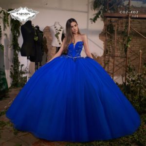 Quinceanera - A woman posing for a picture in a blue ball gown