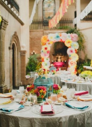 A Quinceanera cake decorating table set with plates and napkins