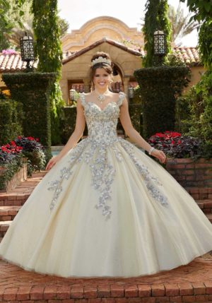 Floral Quinceañera dresses, featuring a woman posing for a picture in a Quinceañera dress