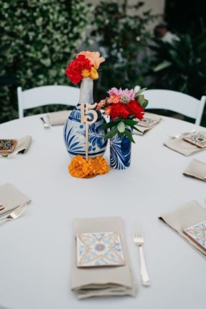 Elegant Quinceanera centerpieces - A white table with a vase of flowers as a centrepiece