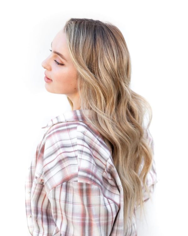 A Quinceanera girl with long blonde hair wearing a plaid shirt