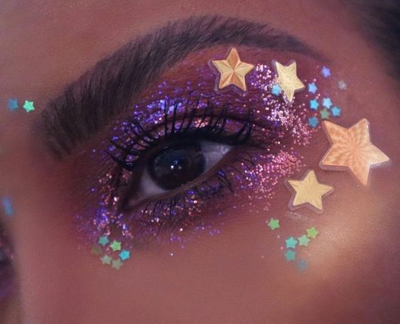 A close up of a person with glitter on their eyes, showcasing euphoria makeup looks for Quinceanera