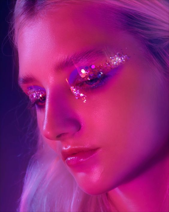 Euphoria, a woman with glitter on her eyes, shines at a Quinceanera celebration