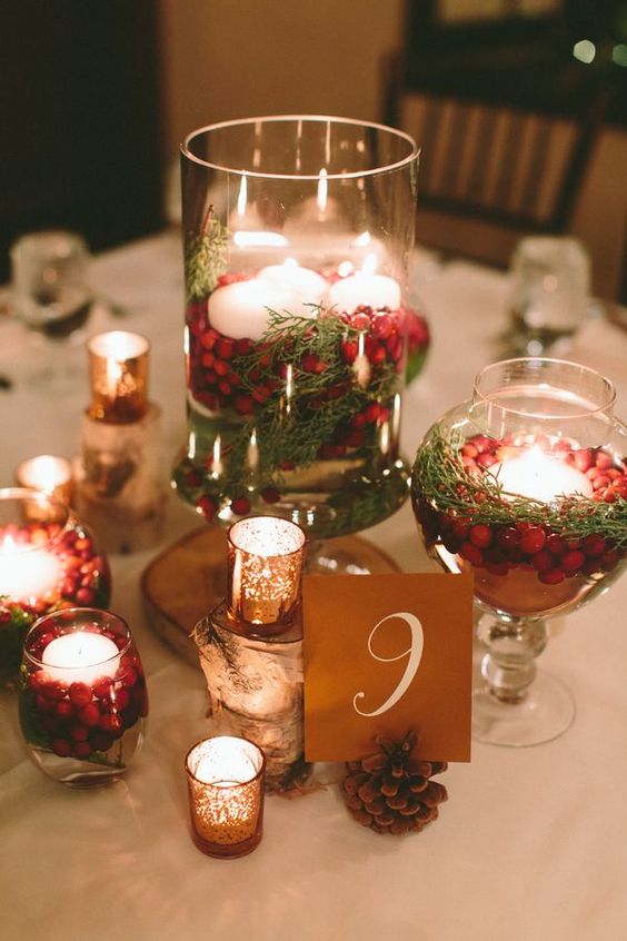 Quinceanera Centerpiece, a table topped with a glass vase filled with candles