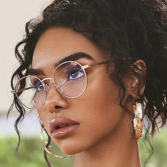A woman wearing sunglasses and a necklace