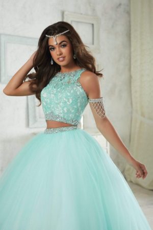 A woman in a blue dress posing for a picture in Disney-inspired Quinceañera dresses.